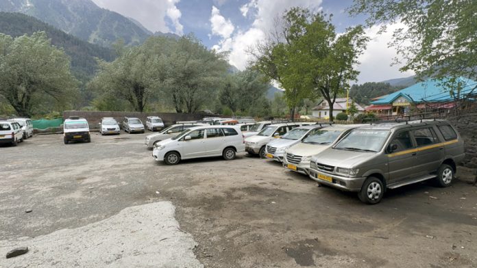 Cabs parked in stands in absence of tourists in Pahalgam. -Excelsior/Sajad Dar Cabs parked in stands in absence of tourists in Pahalgam. -Excelsior/Sajad Dar