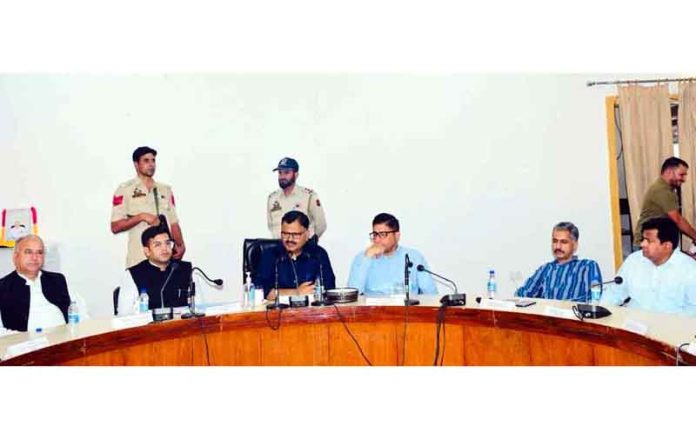 Minister Javed Ahmed Rana chairing a meeting at Rajouri on Saturday.