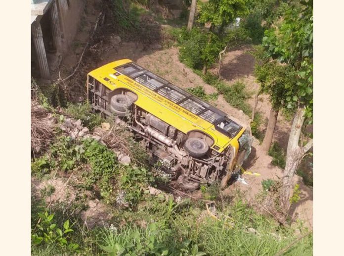 School bus lying in gorge in Manjakote. — Excelsior/Imran