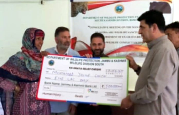 MLA Pahalgam giving an ex-gratia relief cheque to a victim on Sunday.