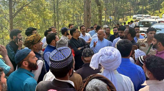 Minister Javed Rana interacting with people near LoC in Balakote on Thursday.
