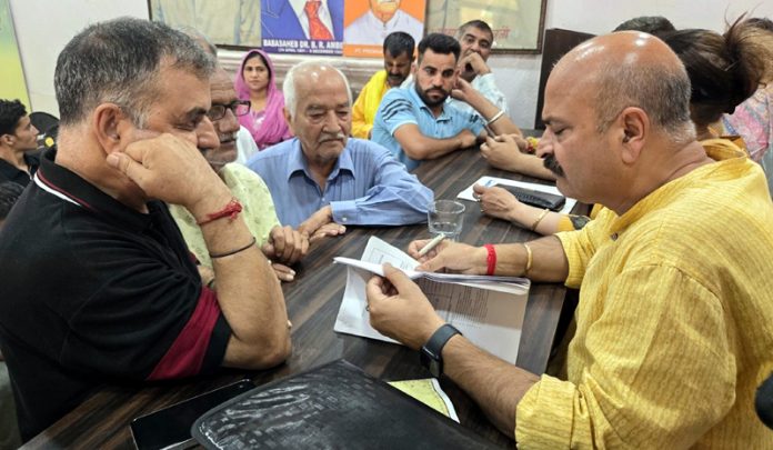 MLA Yudhvir Sethi interacting with people during a grievances redressal camp in Jammu.