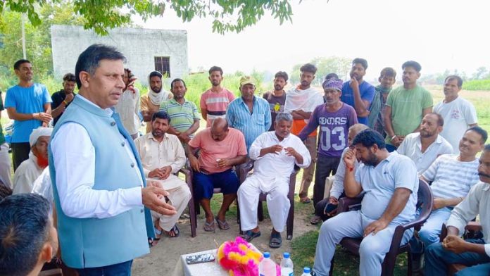 MLA Kathua Dr. Bharat Bhushan interacting with villagers during constituency tour.