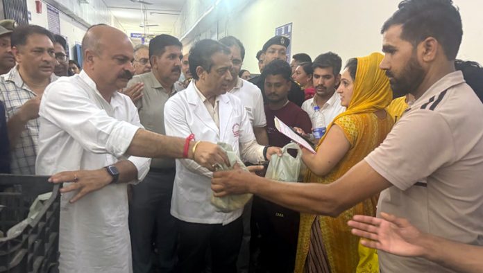 MLA Yudhvir Sethi distributing fruits among the patients at SMGS Hospital in Jammu.