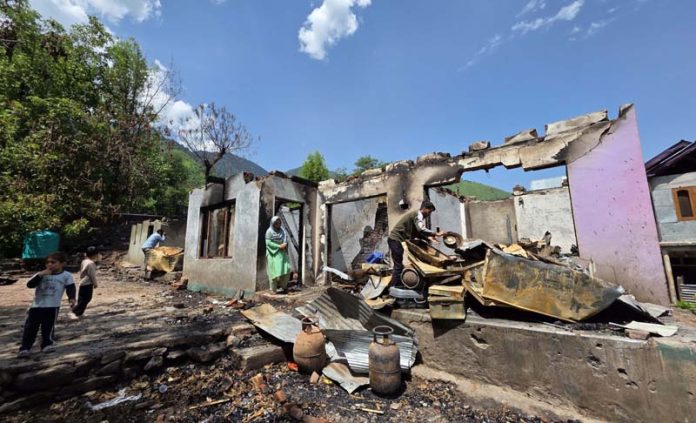 Victims of cross-border shelling near their damaged houses at Salambad village of Uri. -Excelsior/Aabid Nabi
