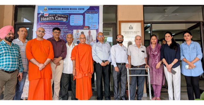 Swami Yajnadharananda posing along with others during a health camp in Jammu.