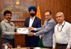DC Doda presenting certificate to J&K Bank officer on Tuesday.