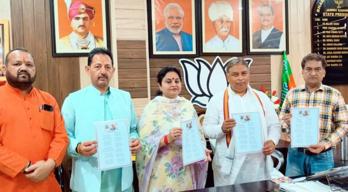 BJP state president, Sat Sharma releasing a poem in Hindi on Monday.