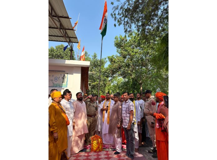 Gangadhar Ji Maharaj hoisting National Flag during a function in Jammu on Tuesday.