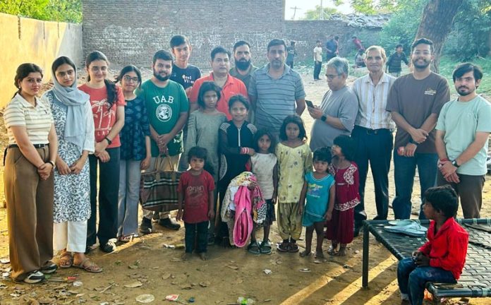 Dr Deepak Kumar along with students of GMC Jammu during clothing donation event at Maratha Basti, Jammu.