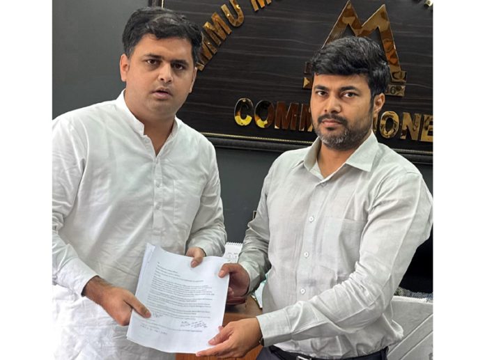 Neeraj Kundan submitting memorandum to Devansh Yadav.