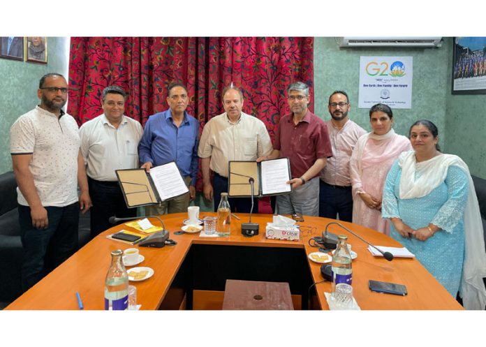 Representatives of Fatima Foundation and IUST during signing of an MoU at University campus in Awantipora.