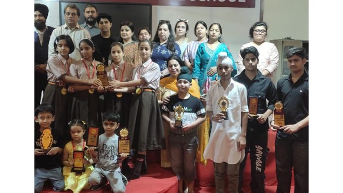 Winners posing along with trophies alongside dignitaries.