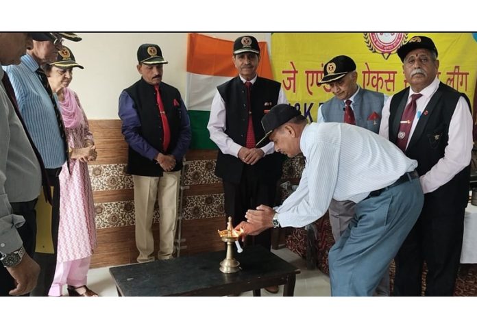 An army veteran lighting the traditional lamp to start the AGM of JKESL in Jammu on Monday.