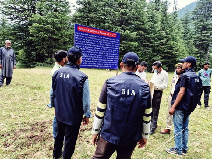 SIA sleuths attaching property at Handwara on Monday.