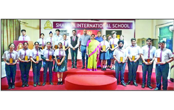 Dignitaries posing along with students during a programme.