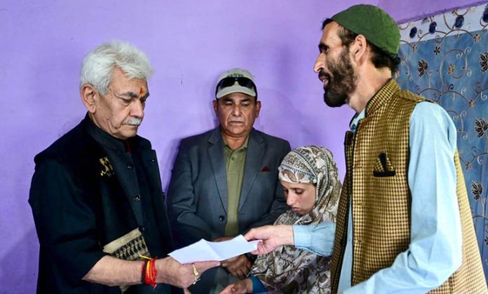 LG Manoj Sinha handing over appointment letter to Adil Shah’s wife in Anantnag on Saturday.