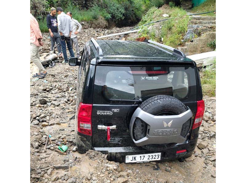 A Bolero vehicle trapped in debris in Pranu area of Bhaderwah.-Excelsior/Tilak Raj