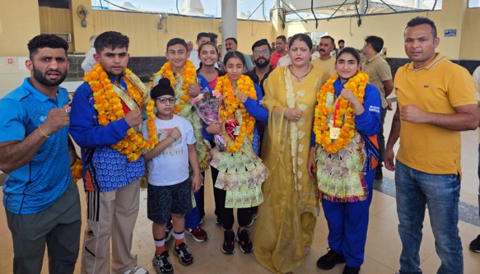 Wushu players receiving grand welcome at Jammu Airport.