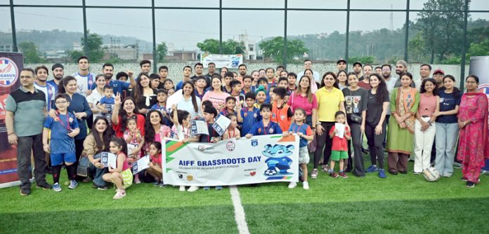 Youngsters posing displaying medals alongside whole posing dignitaries. Youngsters posing displaying medals alongside whole posing dignitaries.