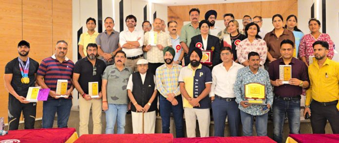 J&K Master Games athletes and dignitaries posing for a group photo during felicitation ceremony at Amar Singh Club, Jammu.