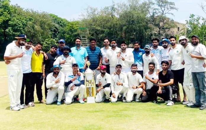 Winning team posing along with trophy. Winning team posing along with trophy.