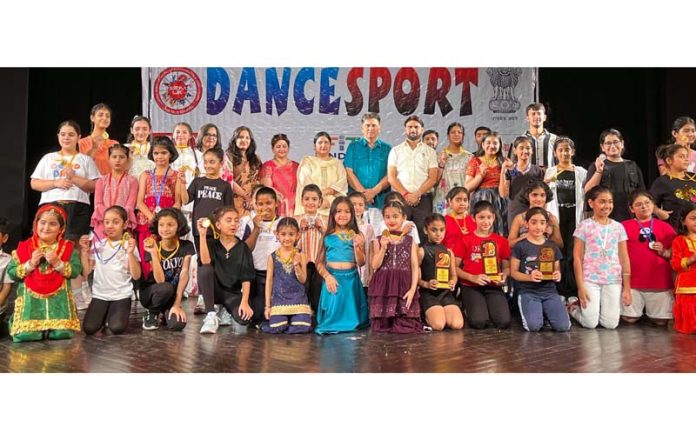 Dignitaries posing along with students during a programme.