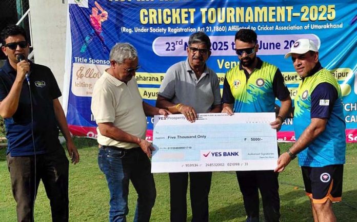 A player receiving a cheque for man of the match during prize distribution ceremony.