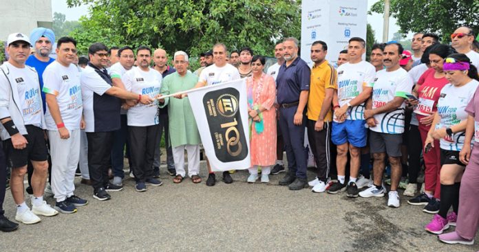 Sports Minister Satish Sharma flagging off ICC Jammu's 10K & 5K Run at University of Jammu. — Excelsior/Rakesh