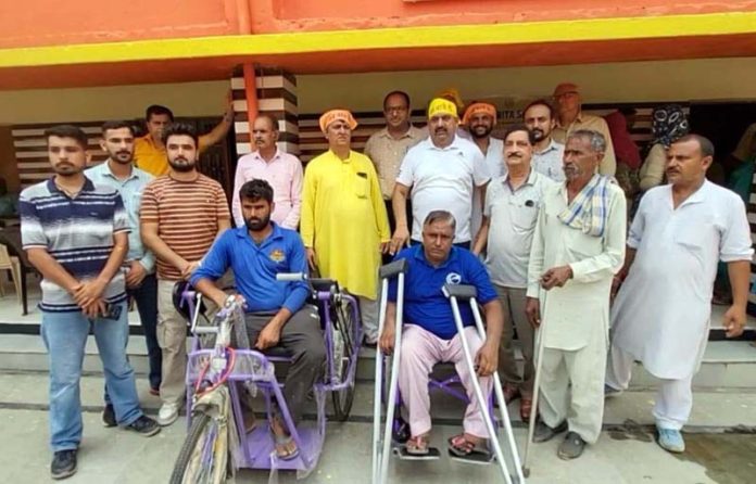 People being provided with assistive devices. People being provided with assistive devices.