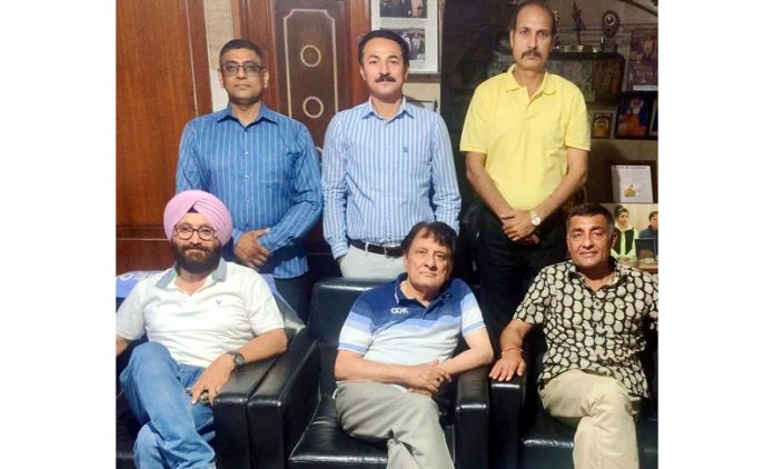 J&K Athletic Association members posing during a meeting.