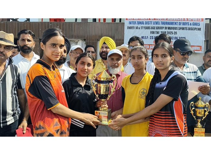 Winning team members receiving trophy.