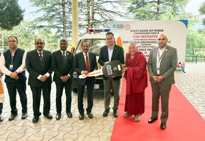 Challa Sreenivasulu Setty, Chairman, SBI handing over keys of ambulance to representatives of The Dalai Lama Trust on Friday.