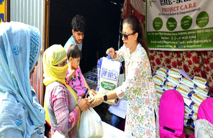 Members of NGO ‘The Sara’ distributing ration to cross border shelling hit families in Poonch.