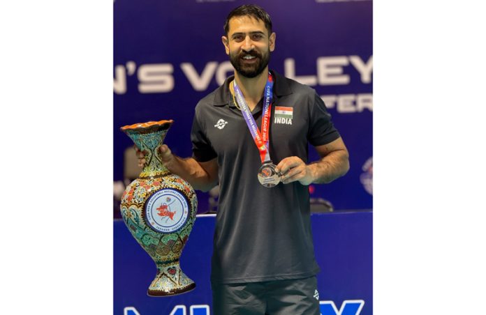 J&K’s Saqlain Tariq posing along with trophy and medal.