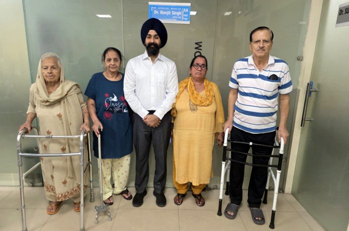 Dr Ranjit Singh posing with patients on whom he performed joint replacement surgeries.
