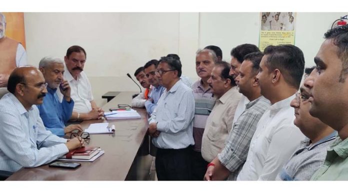 Sham Lal Sharma and Mohan Lal Bhagat listening to deputations during public darbar at BJP Hqrs on Monday.