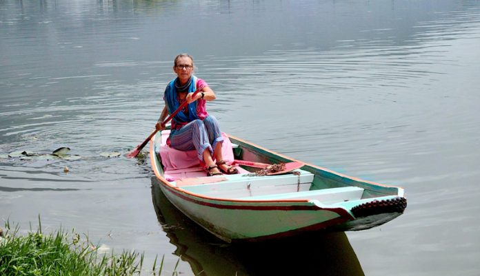 Dutch woman rowing boat on Dal Lake in Srinagar on Sunday. -Excelsior/Shakeel Dutch woman rowing boat on Dal Lake in Srinagar on Sunday. -Excelsior/Shakeel