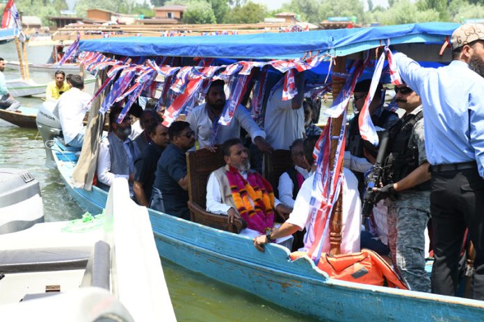 J&K Apni Party President Altaf Bukhari leading a Shikara rally in Dal Lake on Wednesday. -Excelsior/Shakeel