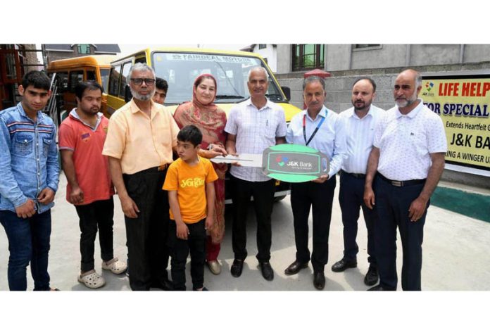 J&K Bank’s DGM (CSR), Anup Bhat handing over keys of a vehicle to LHCCC Secretary Dr Aaliya, in Srinagar on Thursday.