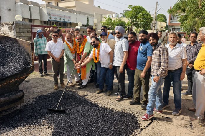 MLA Bahu, Vikram Randhawa starting blacktopping work in Gandhi Nagar area.