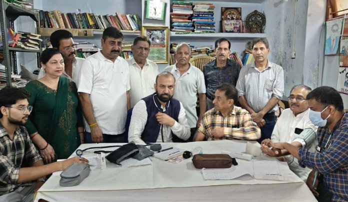 HoD Cardiology GMC & SSH Jammu Dr Sushil Sharma examining patients at New Plots on Sunday. HoD Cardiology GMC & SSH Jammu Dr Sushil Sharma examining patients at New Plots on Sunday.