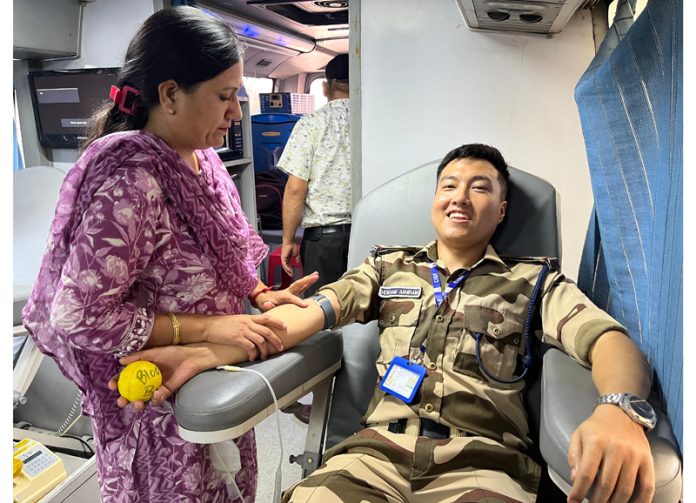 A CISF jawan donating blood during camp at Jammu Airport.