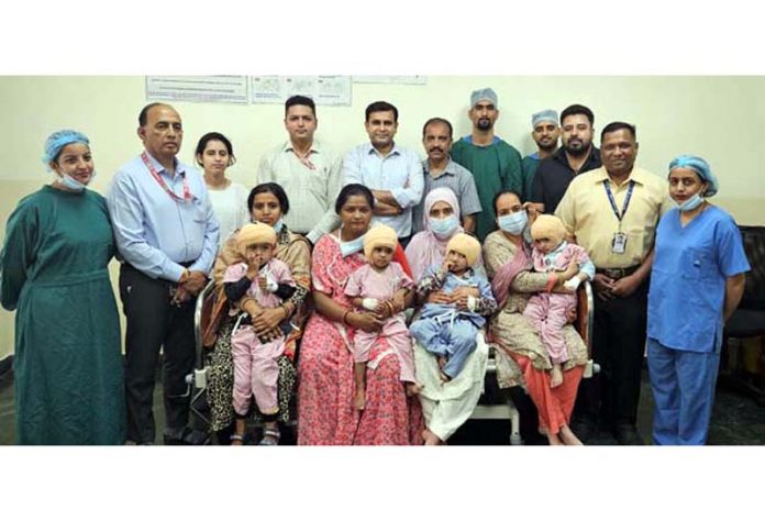 Team of doctors with the children who were given the gift of sound at Shri SMVDNSH Kakryal on Wednesday.