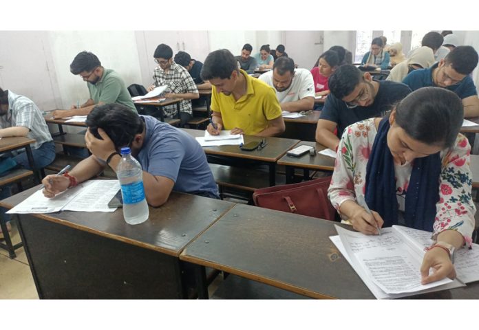 Students taking tests at SR College in Jammu.