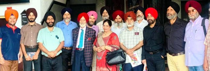 JKAACL Secretary Harvinder Kaur with writers and intellectuals at Tagore Hall in Srinagar on Tuesday.