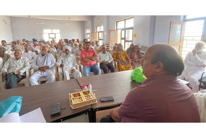 Dr Davinder Manyal addressing a gathering during the VKSA event in a village of Samba district on Monday.