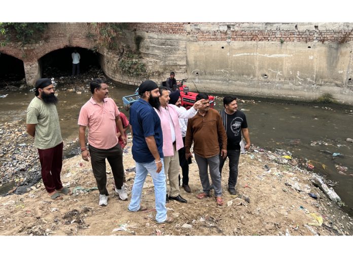BJP leader, Baldev Singh Billawaria reviewing drain cleaning work in Jammu on Friday.