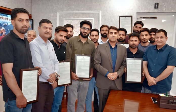 Javid Dar distributing appointing letters among newly recruited Junior Assistants.