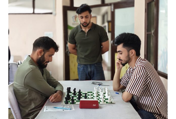 Players displaying keen interest during a Chess game at Srinagar.